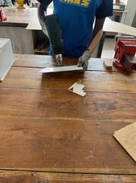 Fabricating the 1:3 prototype — heat-bending the acrylic seat-and-backrest to 98°.